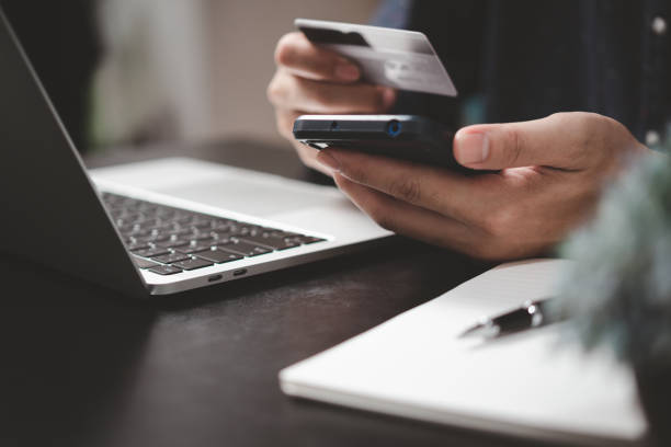 istock man paying and shopping with smartphone application e commerce wallet app technology. Man using mobile phone and credit card paying via mobile banking. 1433306470