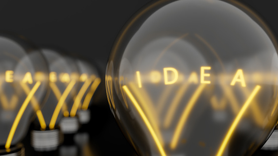 Light bulbs with shining fibres in shapes of IDEA concept related words isolated on black background. 3d illustration