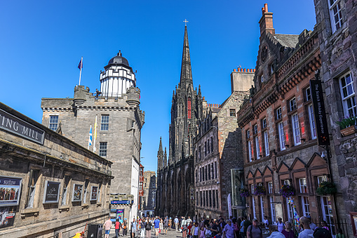 Edinburgh, Scotland- July 11, 2022: The street view of Royal Mile, Edinburgh. The Royal Mile is a succession of streets forming the main thoroughfare of the Old Town of the city of Edinburgh in Scotland.