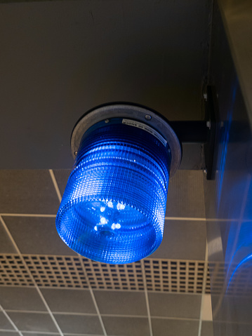 A cylindrical blue light on the ceiling at the Huntington Place station for the Detroit People Mover in Detroit, Michigan