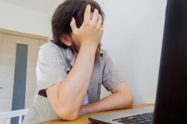 istock Sad man covering his face 1433308920
