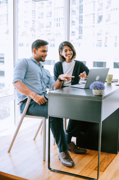 istock Smiling business partners working together in modern office 1433310166