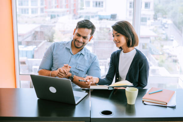 istock Smiling business partners working together in modern office 1433310179