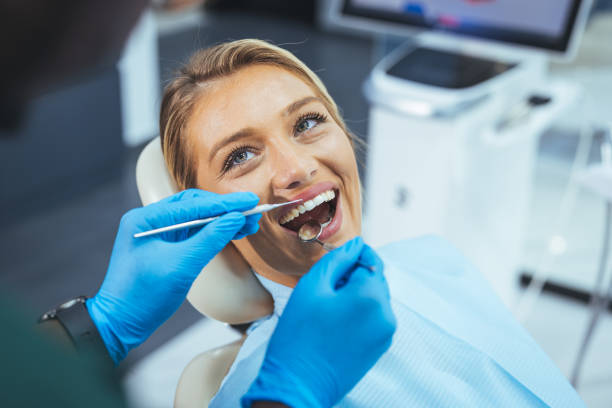 Dentist and patient in dentist office stock photo