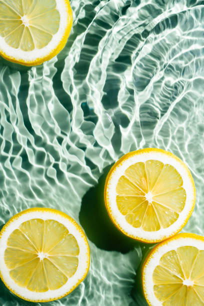 istock Transparent fresh exhilarant wave water with flecks background, lemon citrus slices. Vertical. Healthy eating. Flat lay 1433311976