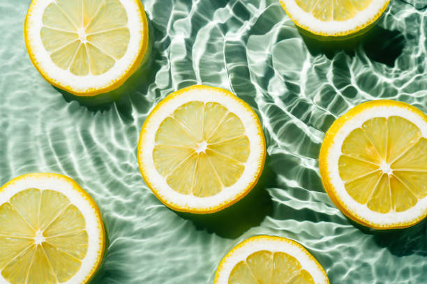 istock Transparent fresh exhilarant wave water with flecks background, lemon citrus slices. Healthy eating beach. Flat lay 1433311982