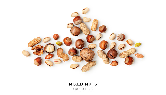 Mixed nuts creative layout isolated on white background. Healthy eating and dieting food concept. Peanut, walnut, hazelnut, pistachio and macadamia composition and design element. Top view, flat lay