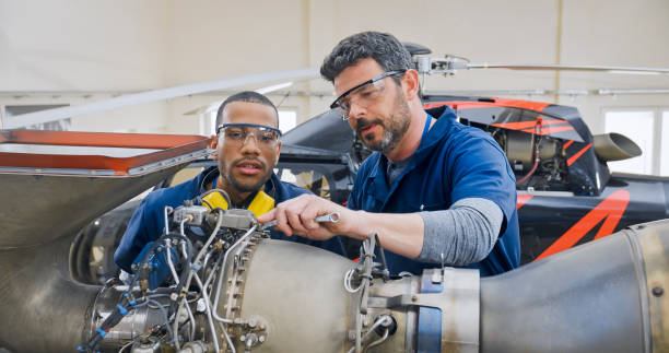 istock Mechanics repairing helicopter engine 1433312508
