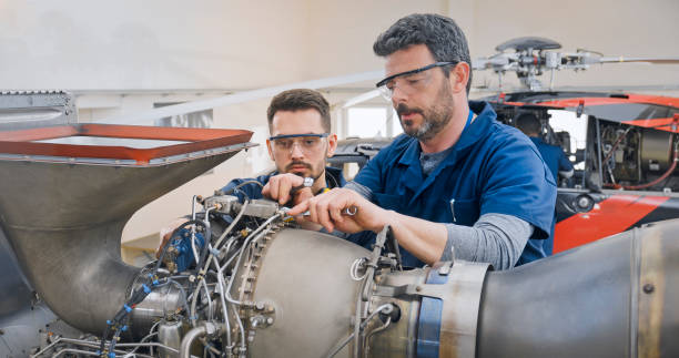 istock Mechanics repairing helicopter engine 1433312513