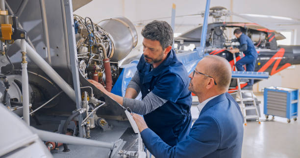 istock Mechanics repairing helicopter engine 1433312519