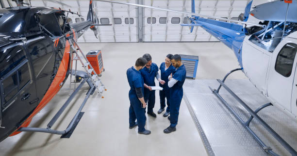 istock Mechanics standing near helicopter 1433312532