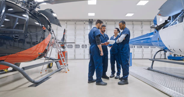 istock Mechanics standing near helicopter 1433312542
