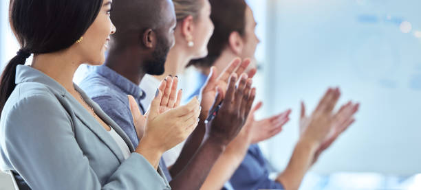 motivation, innovation and community support by clapping workers at a conference or presentation. diverse team applause, cheering and inspired at a training seminar or meeting, positive audience - training business seminar clapping imagens e fotografias de stock