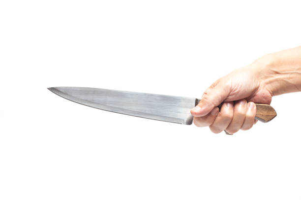 istock Kitchen knife in a man's hand, isolated on white background. 1433314635