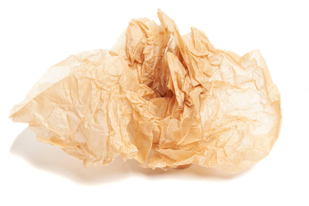istock crumpled brown baking paper sheets isolated on white background 1433316784