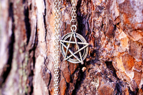 istock Pentagram symbol necklace on tree bark background 1433317995