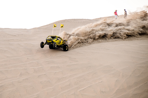 Doha, Qatar- April 23, 2022: Off-road vehicle on the sand dunes of the Qatar desert.