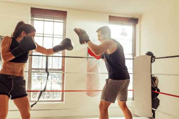istock Female boxer training with her personal trainer at the gym 1433320883
