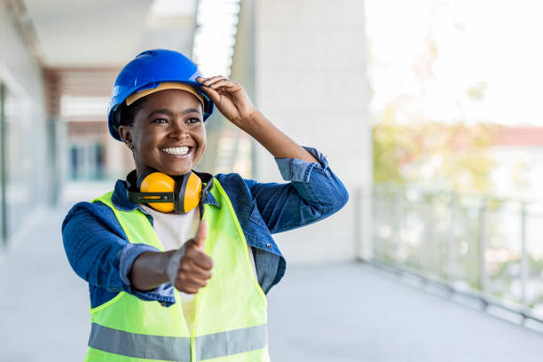 istock Cheerful young female engineer on a harbor showing thumb up. 1433321176
