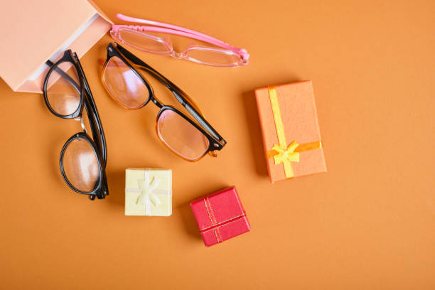 istock several different glasses and gift boxes on a brown background copy space, discounts and promotions in the optics store 1433322692