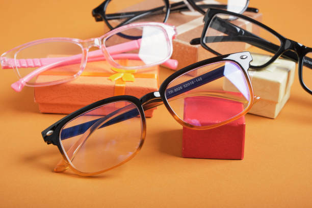 istock glasses on a small rted gift box, small gift boxes and different frames for glasses on a brown background copy space, 1433322694