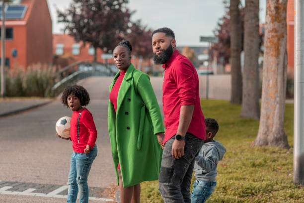 Beautiful black family connecting whilst enjoying an afternoon walk together through the neighbourhood