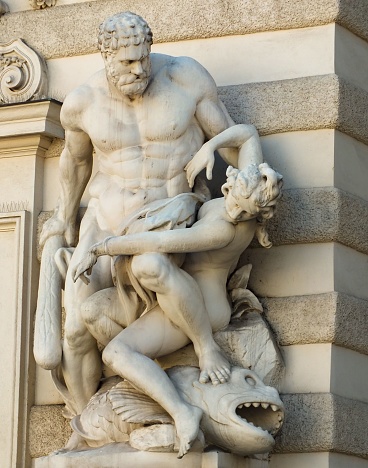 A vertical shot of a Hercules Sculpture in Vienna, Austria