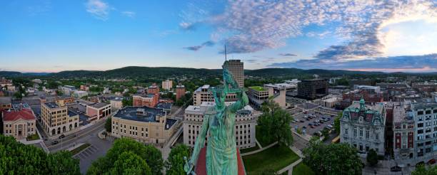 Panoramic aerial shot of the cityscape of downtown Binghamton, with a green statue in the middle A panoramic aerial shot of the cityscape of downtown Binghamton, with a green statue in the middle binghamton ny stock pictures, royalty-free photos & images