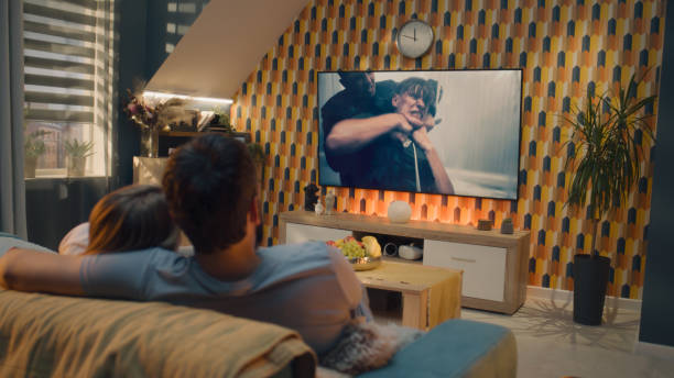 istock Couple watching action movie after workday 1433325902