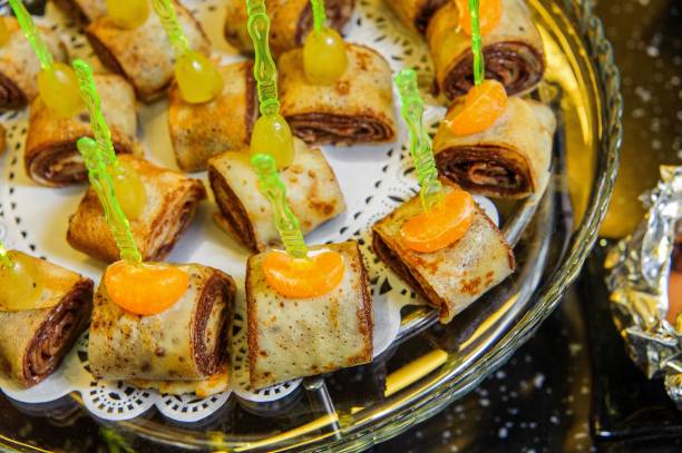 istock Closeup shot of pancake rolls in a silver plate on a buffet table 1433325933