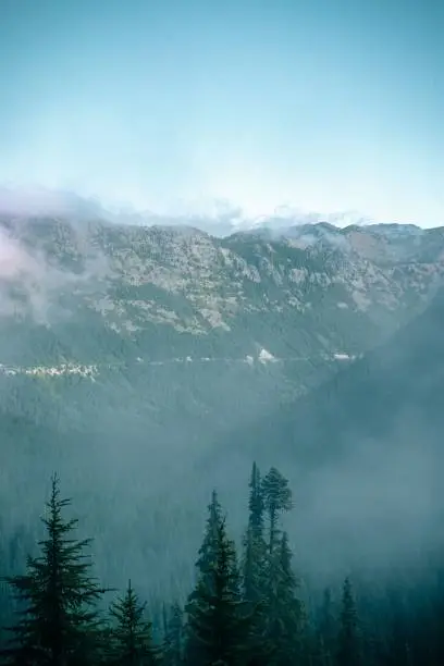 Photo of Beautiful scenery of a rocky mountainous landscape enveloped in mist in daylight