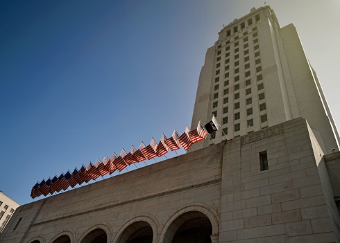 A Los Angeles City Hall building facade under blue bright sky