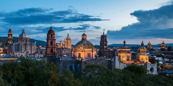 A panoramic view of church domes of San Miguel de Allende, Mexico in twilight