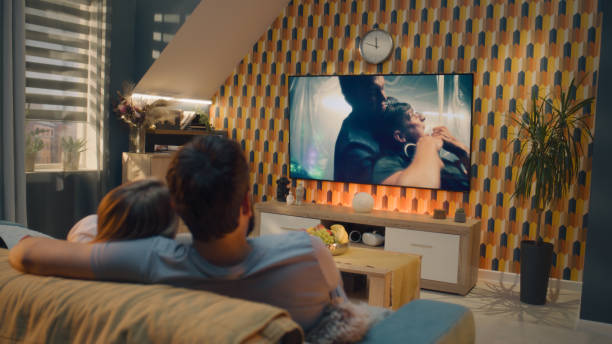 istock Couple watching action movie after workday 1433327939