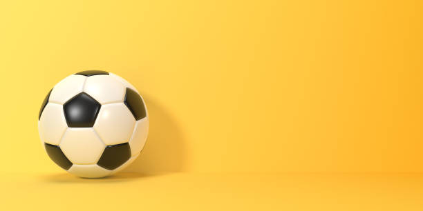istock Soccer ball on a yellow background with copy space 1433329415