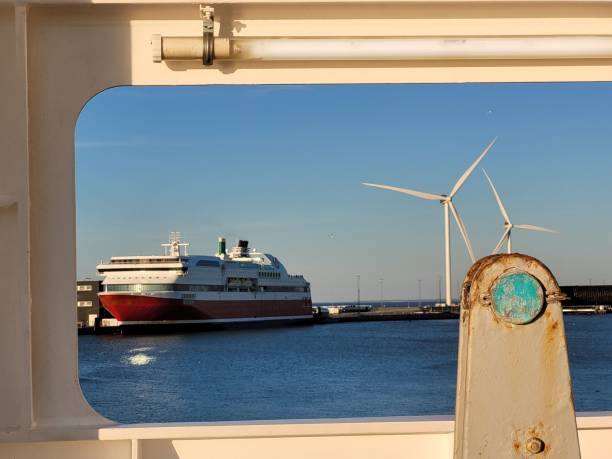 istock Big, white cargo ship view from the shipboard, blue sky and white windmills background 1433329832