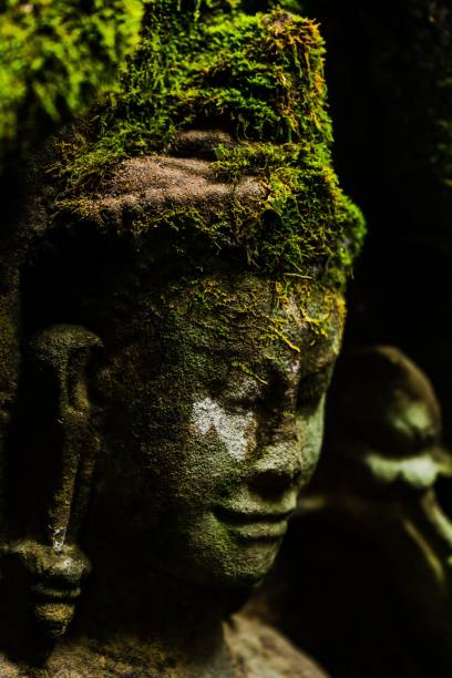 istock Old statue head in a temple in Angkor Wat Cambodia 1433330749