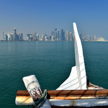 Doha skyline with arabic style Dhow boats in the foreground on a sunny day in Doha, Qatar