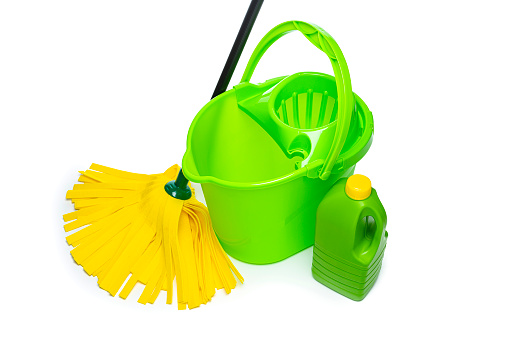 Cleaning concepts: Green and yellow household cleaning products and tools shot from above on white background. Copy space High resolution 42Mp indoors digital capture taken with SONY A7rII and Zeiss Batis 40mm F2.0 CF lens
