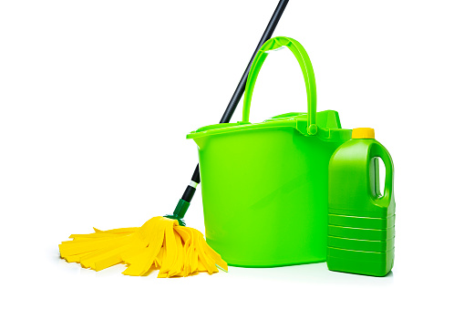 Cleaning concepts: Green and yellow household cleaning products and tools isolated on white background. Copy space High resolution 42Mp indoors digital capture taken with SONY A7rII and Zeiss Batis 40mm F2.0 CF lens