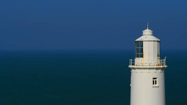 istock Old white lighthouse overlooking the ocean 1433333999