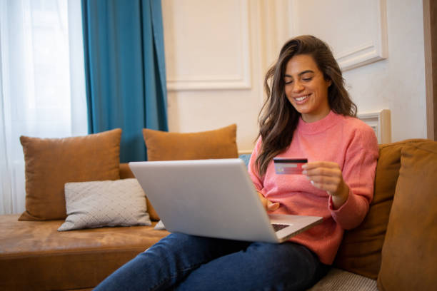 istock Cheerful  woman doing online shopping 1433335791