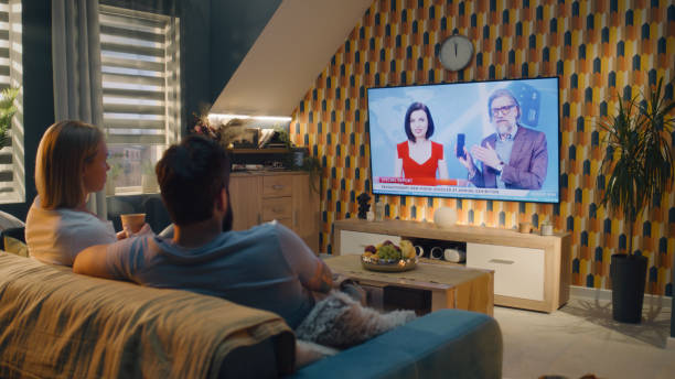 istock Couple watching smartphone presentation on TV 1433338401
