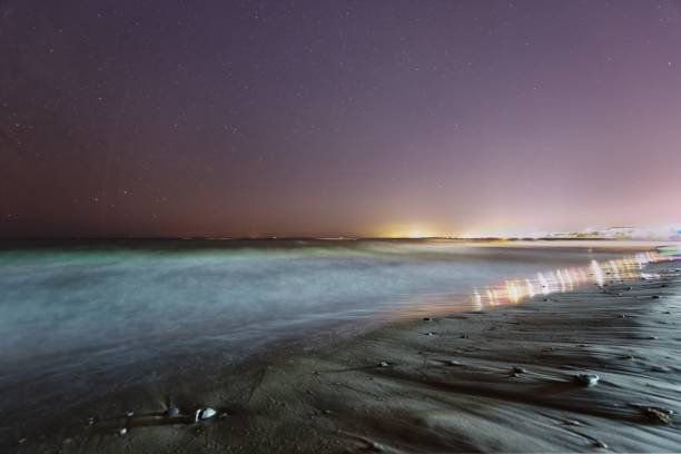 istock Dramatic scenery of a beautiful sky covered in flashy stars and a sandy beach 1433339851