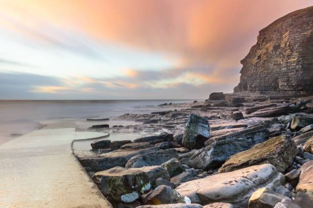 istock Scenic beach and big stones with a sunset cloudscape in the background 1433340853