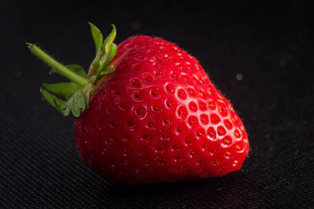 istock Red strawberry in the dark background 1433342479