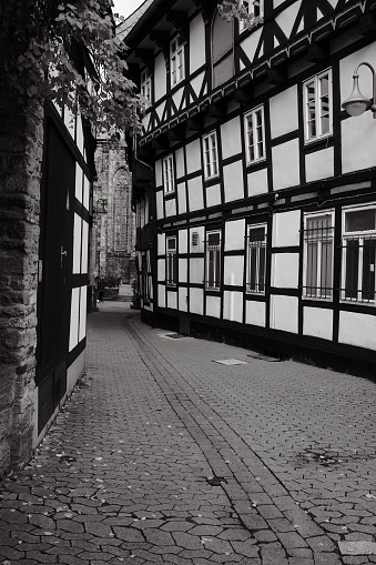 A vertical shot of Marktkirche from the parish courtyard with half-timbered houses in Goslar,Germany