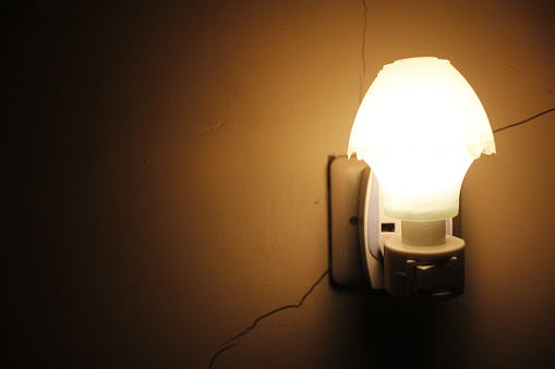 A lamp with a dim light in a room for background