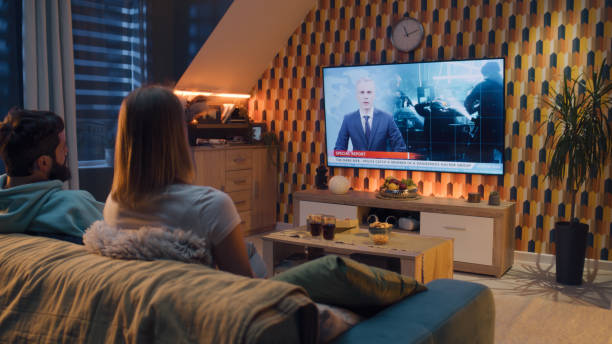 istock Couple watching TV news about hacker group 1433343110