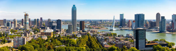 view from drone of rotterdam city with modern districts and erasmus cable-stayed bridge - rotterdam stockfoto's en -beelden